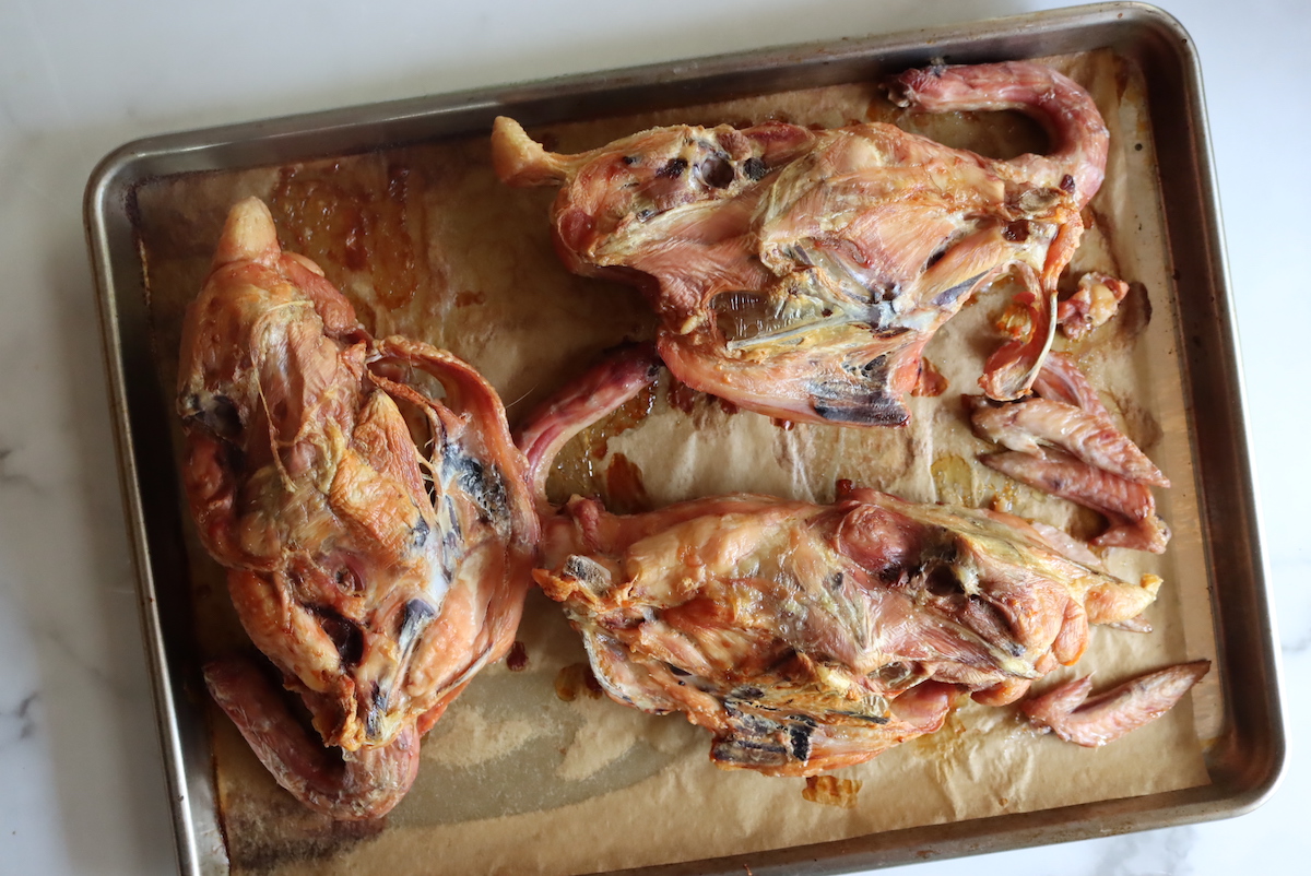 Roasted chicken carcasses and wing tips for making broth
