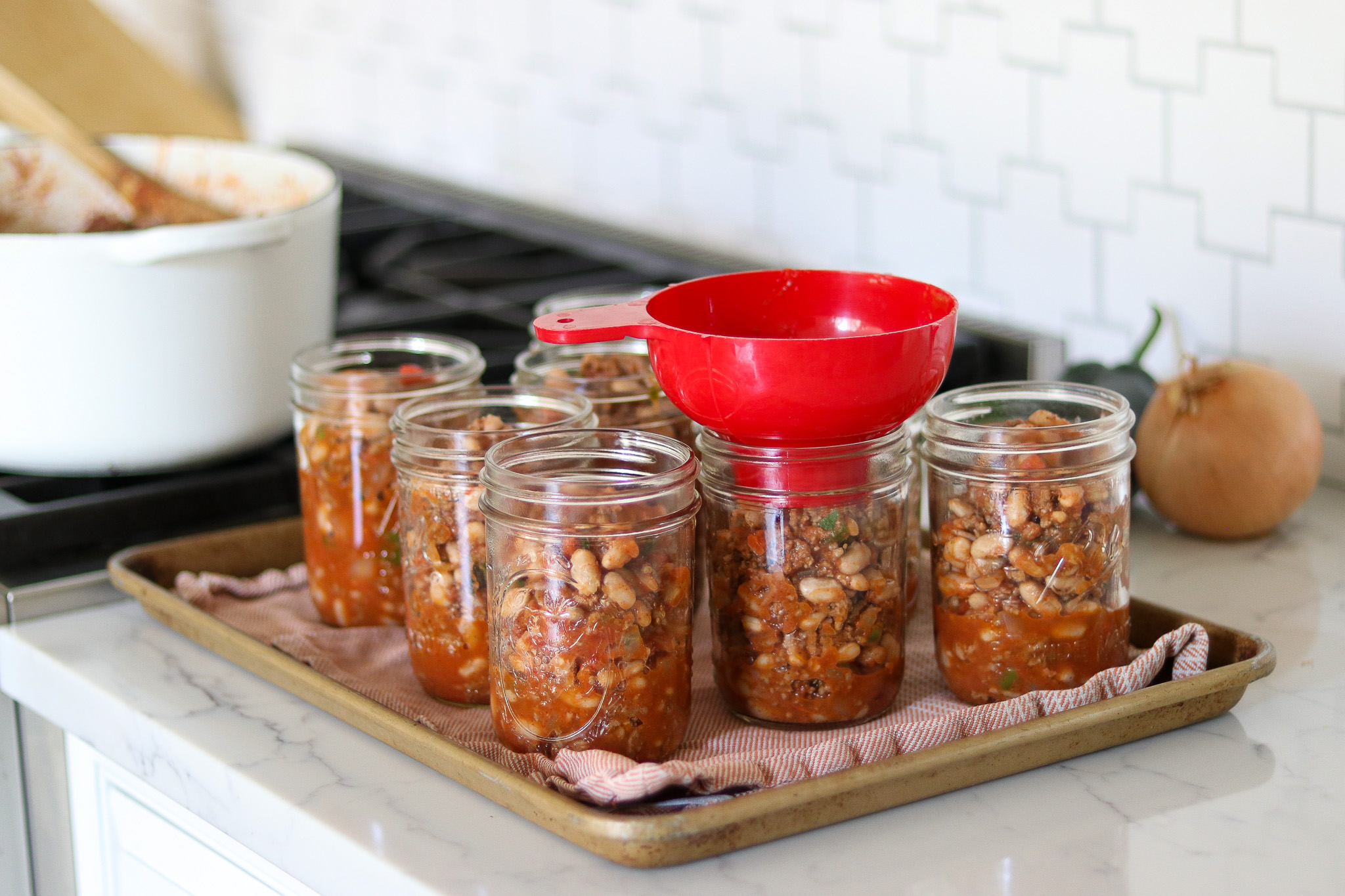 Filling Jars with chili for canning