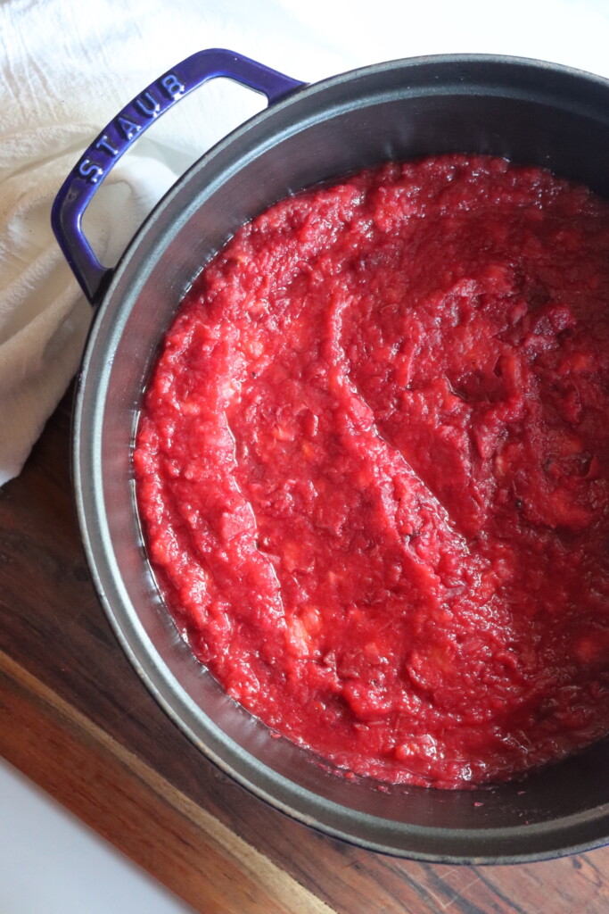 Finished crabapple sauce in a pot, after seeds and skins have been removed by a food mill.