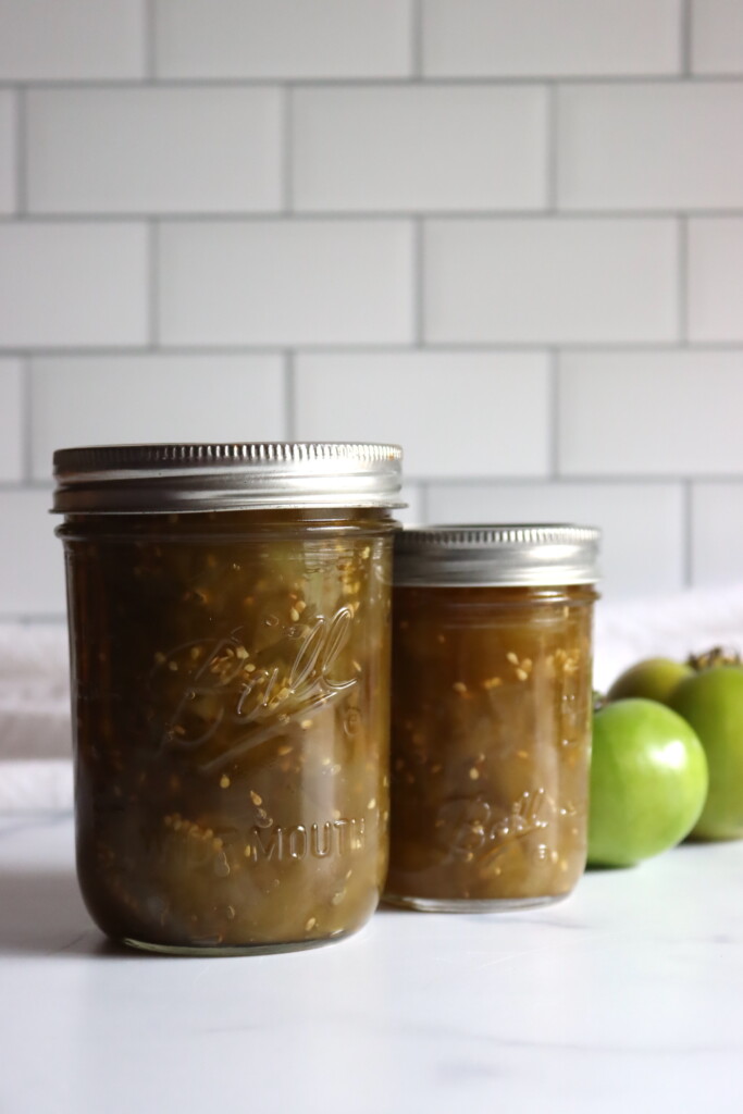 Green Tomato Chow Chow in jars against a white background.