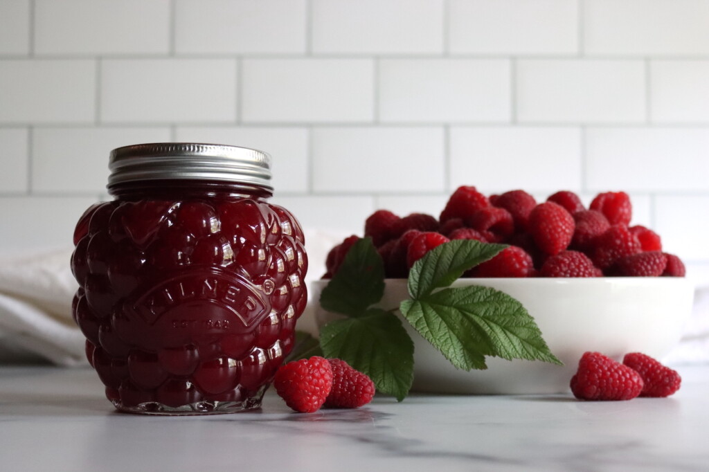 Seedless Raspberry Jam in a raspberry shaped jar.