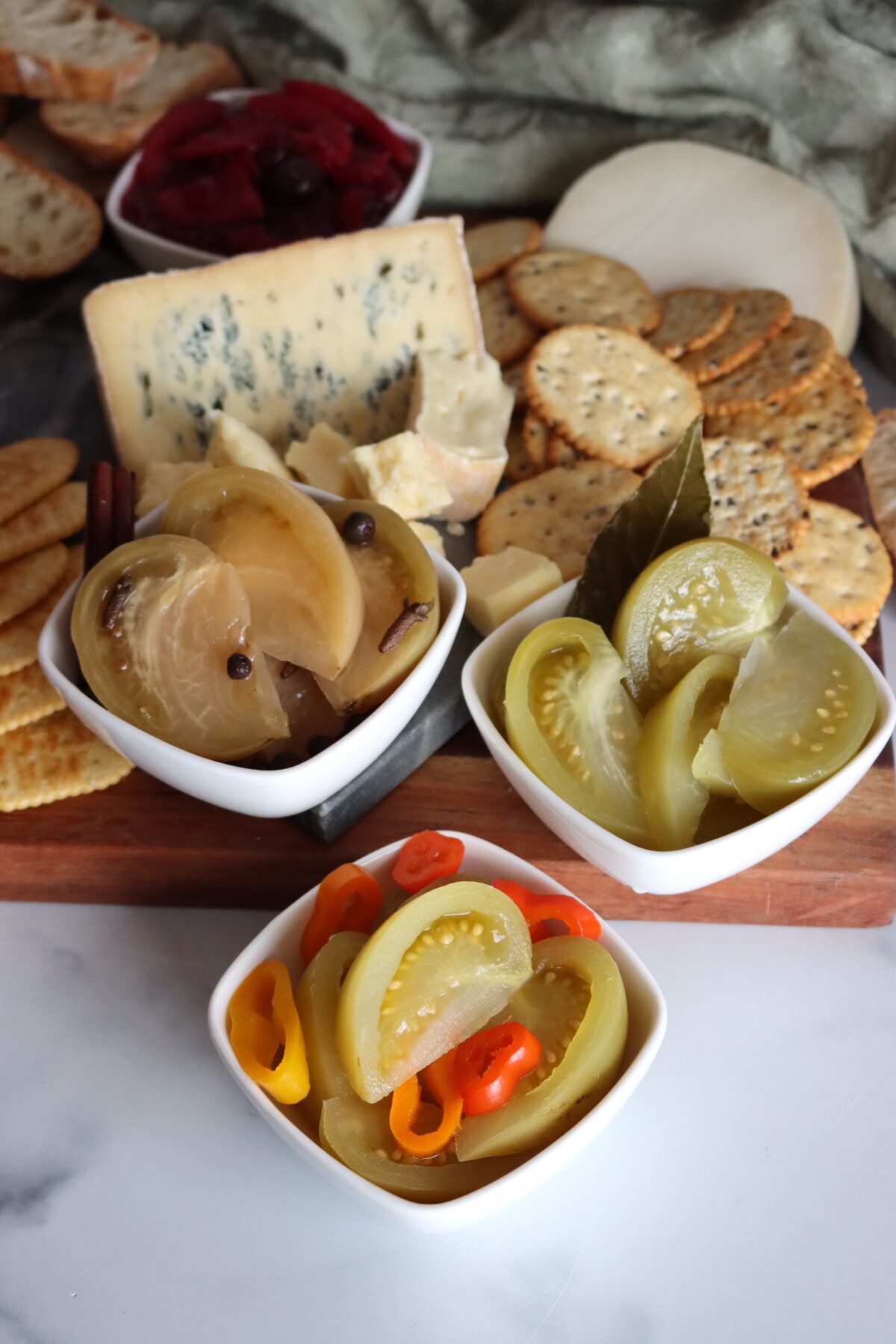 Three types of pickled green tomatoes served on my holiday cheese board.