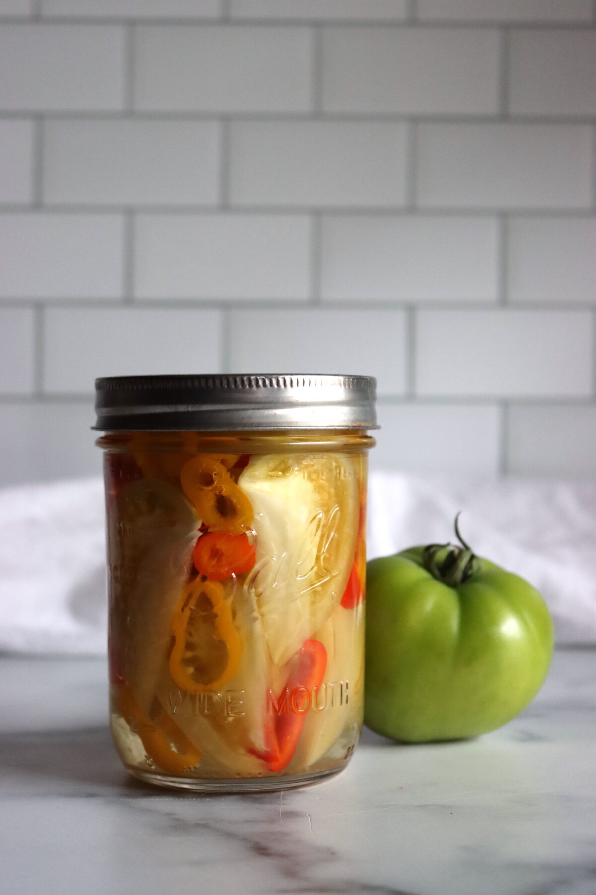Spicy Pickled Green Tomatoes after a few weeks curing in the jars.