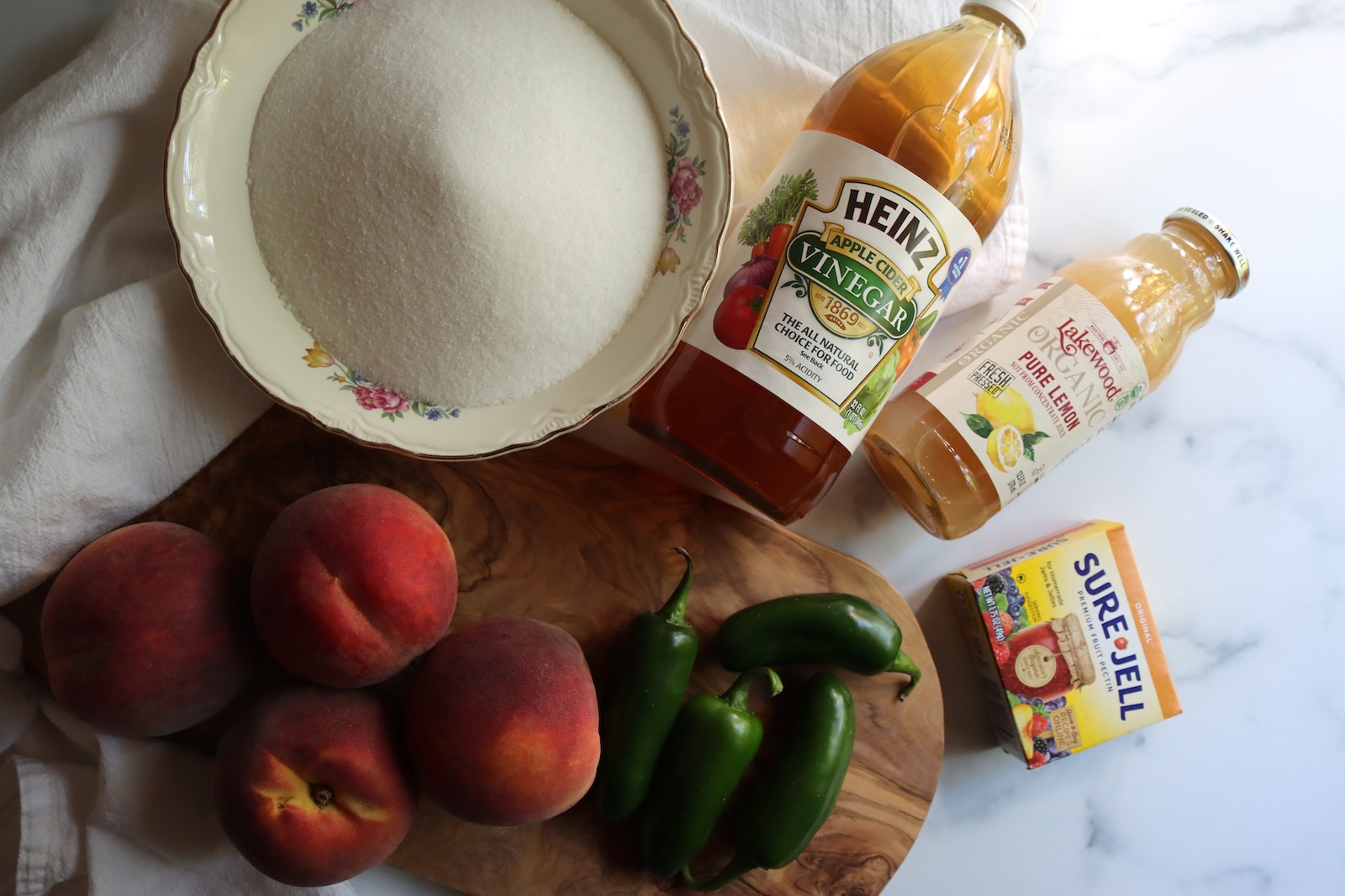 Peach jalapeño jam ingredients: peaches, jalapeños, sugar, cider vinegar, bottled lemon juice, and Sure-Jell pectin