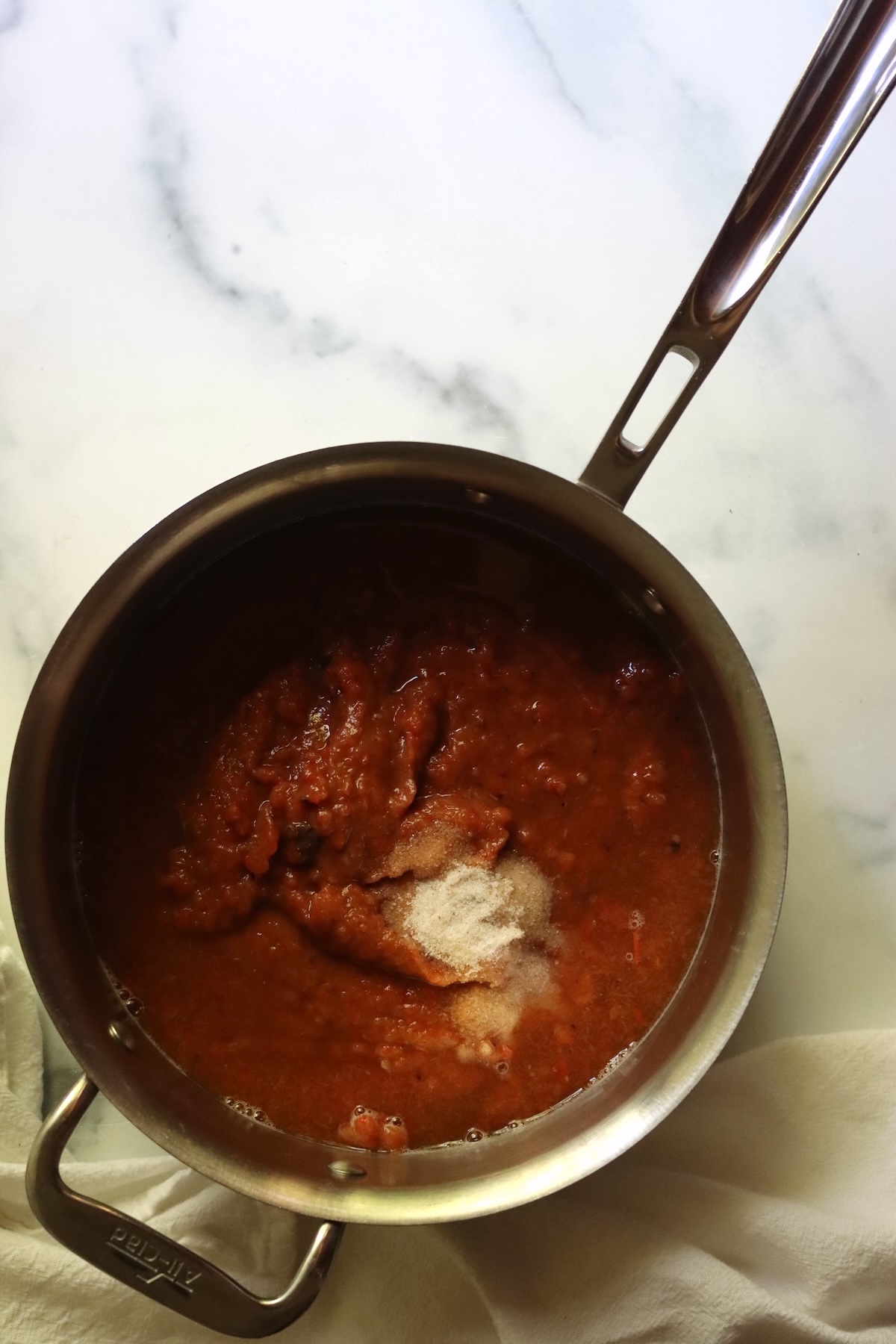 Pureed ajvar in a stainless steel saucepan, ready to cook with the vinegar