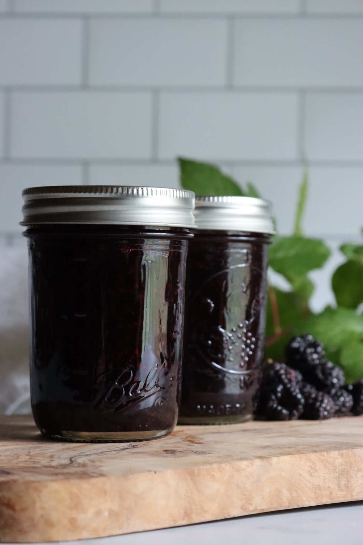 Two half-pint jars of black raspberry jam