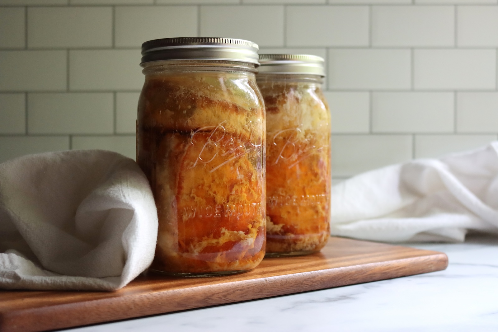 Sealed quart and pint jars of pork chops after pressure canning