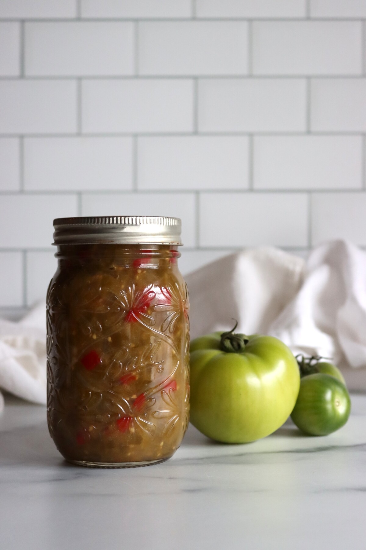 Sealed pint of green tomato hot dog relish with whole green tomatoes